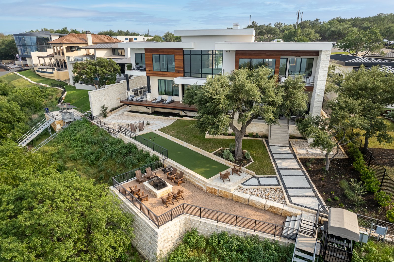 aerial of the terraces, lawn and fire pit stepping down the cliff