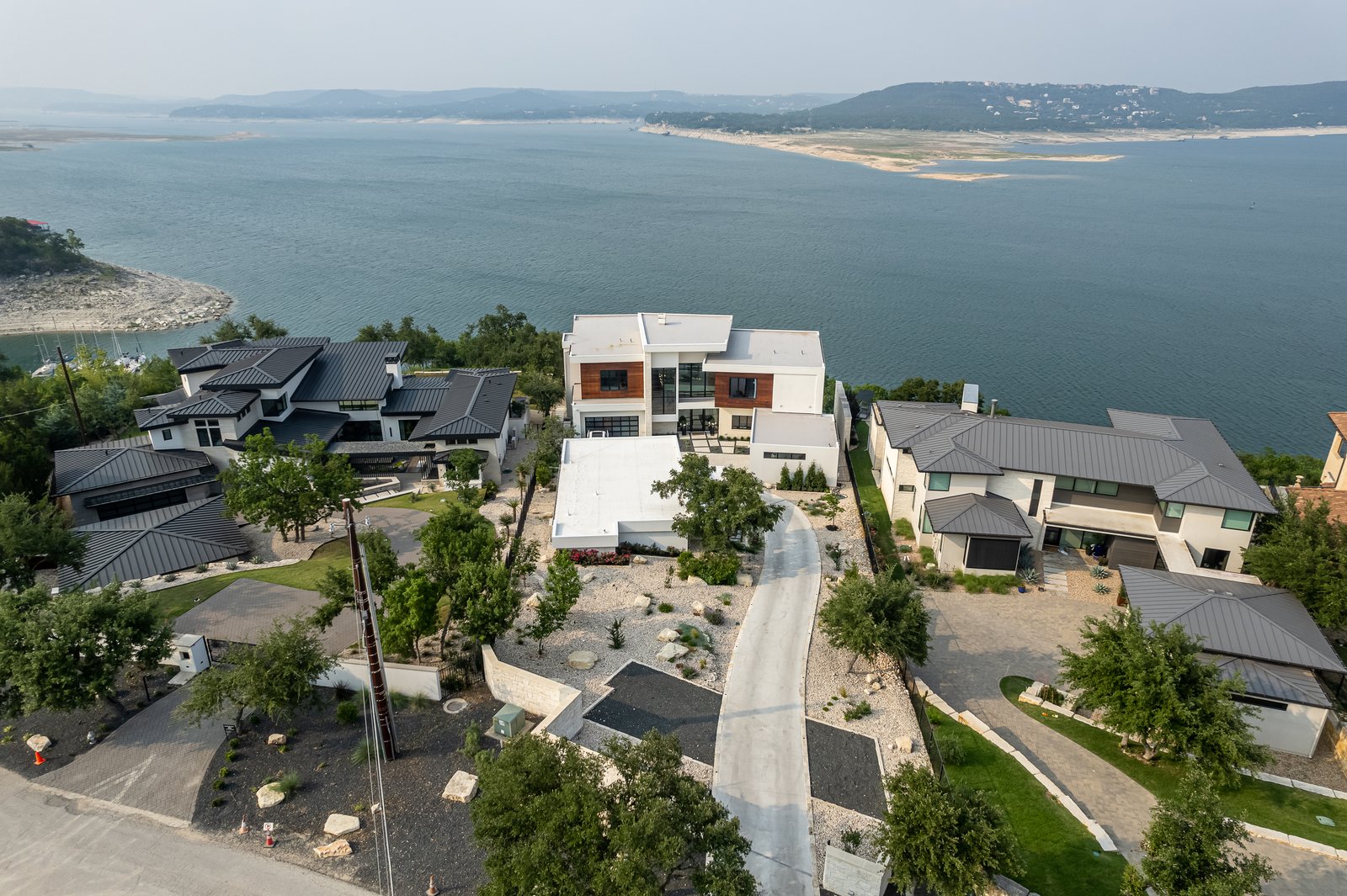 aerial of the house among its neighbors on the lake travis shore