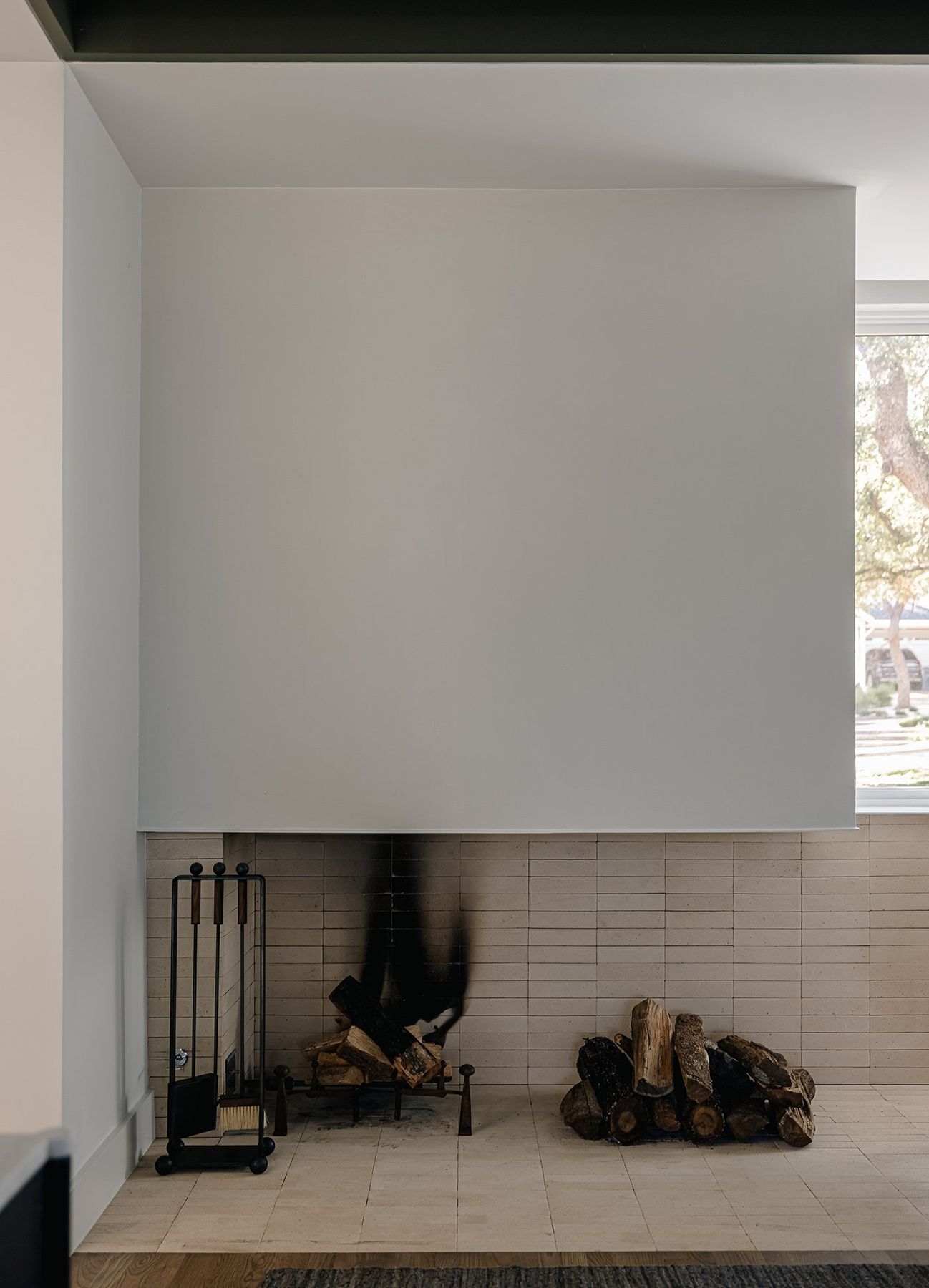 white plaster fireplace with a tiled hearth