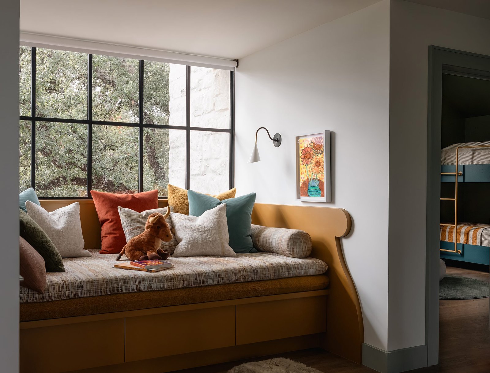 built-in window seat under a steel window, oaks outside
