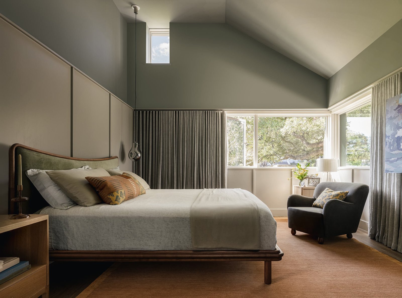 bedroom under a sloped ceiling, windows on two sides