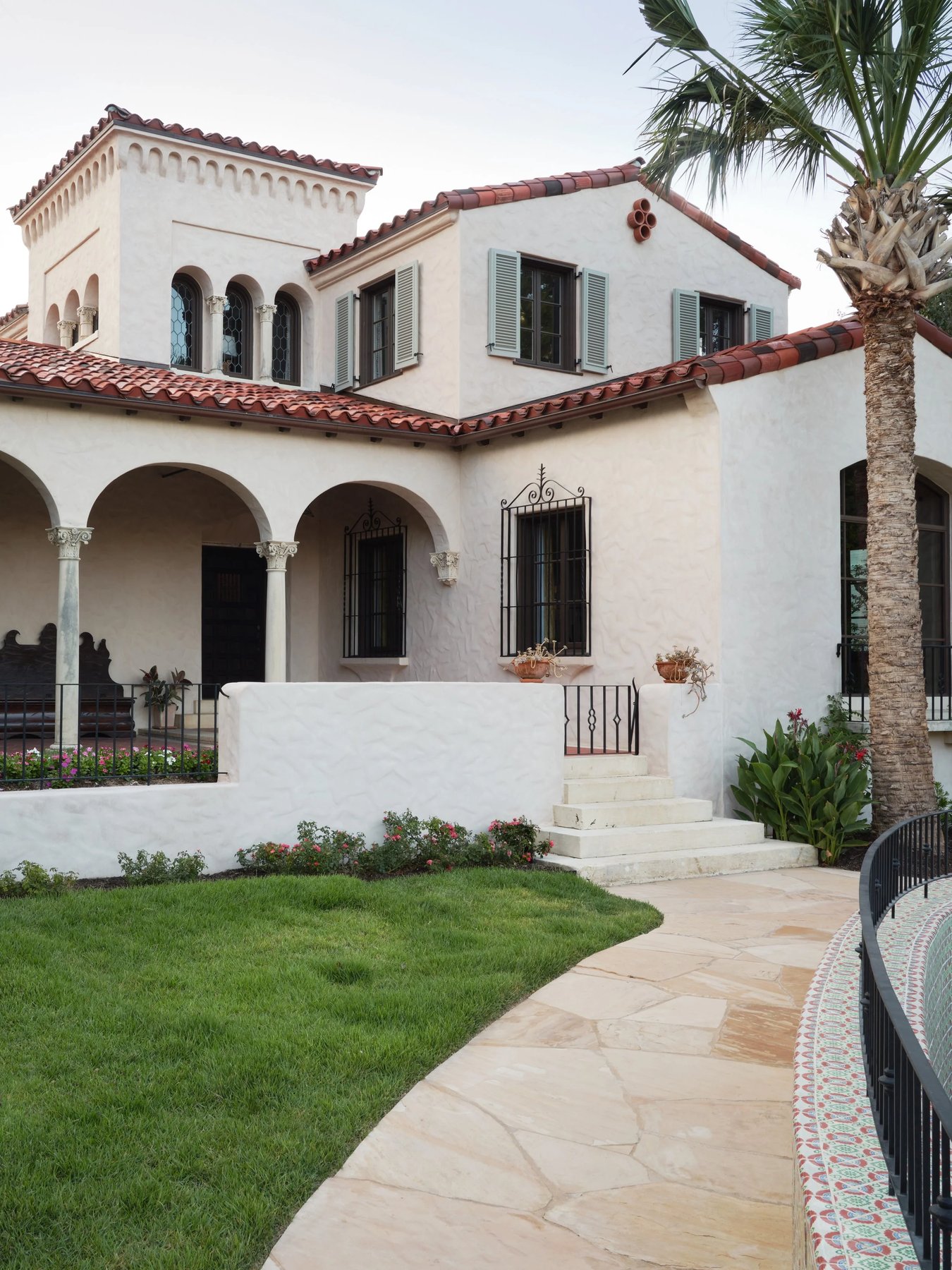 front of the house, arched porch and a palm