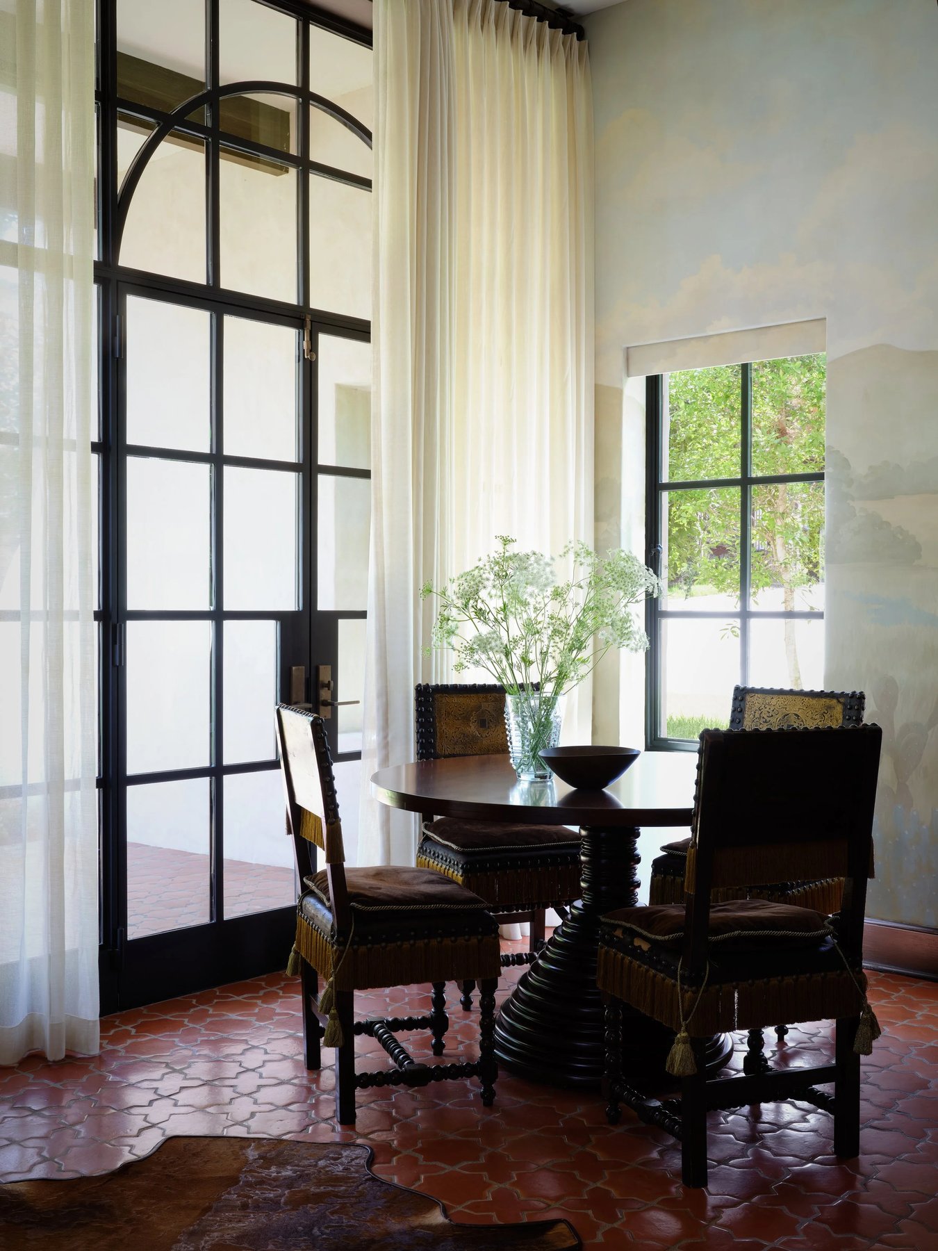 breakfast table by tall steel windows