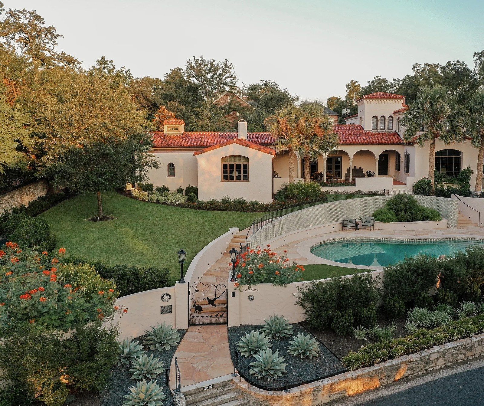 the house above the garden and pool, tile roofs among oaks
