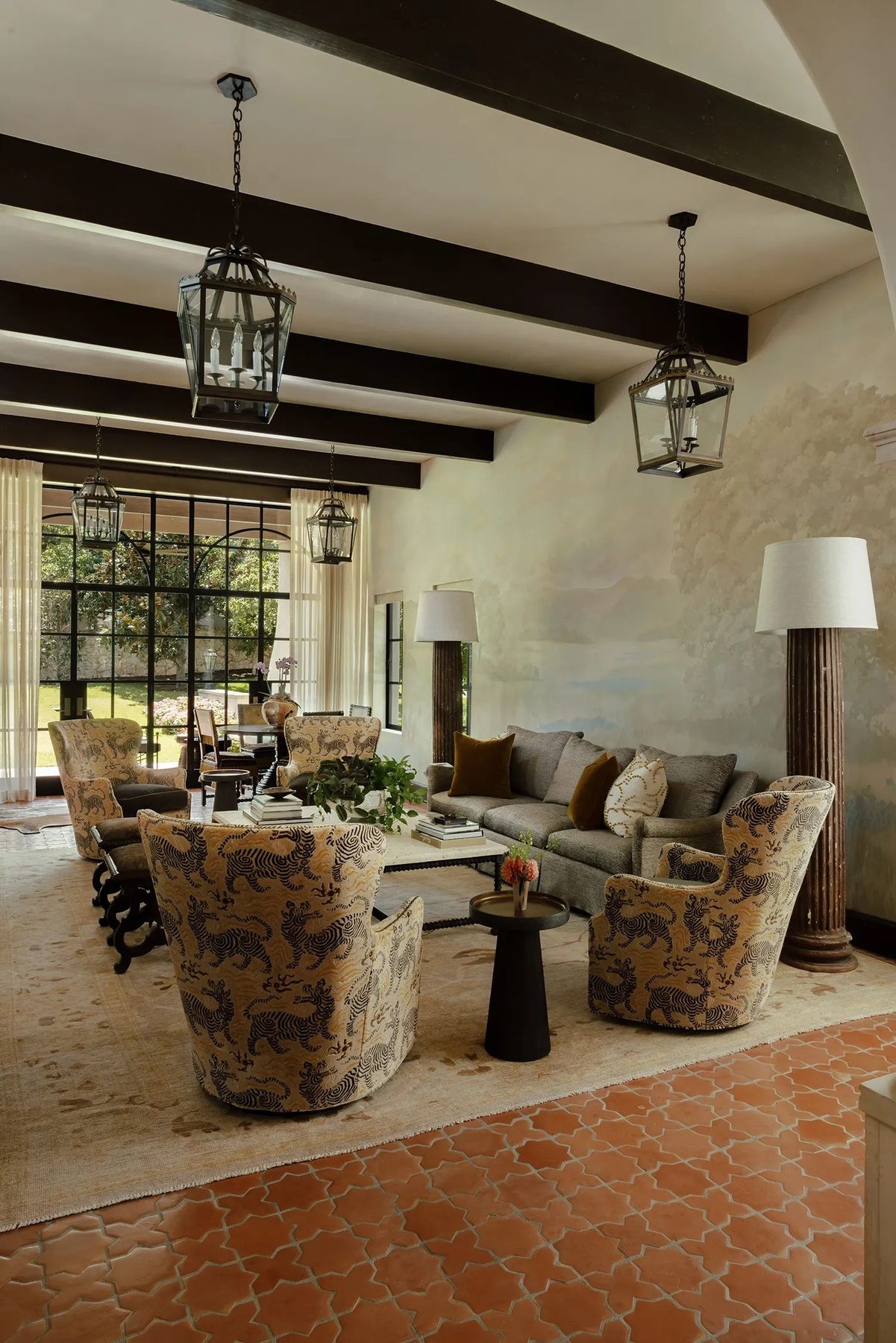 living room under dark beams, terracotta floor