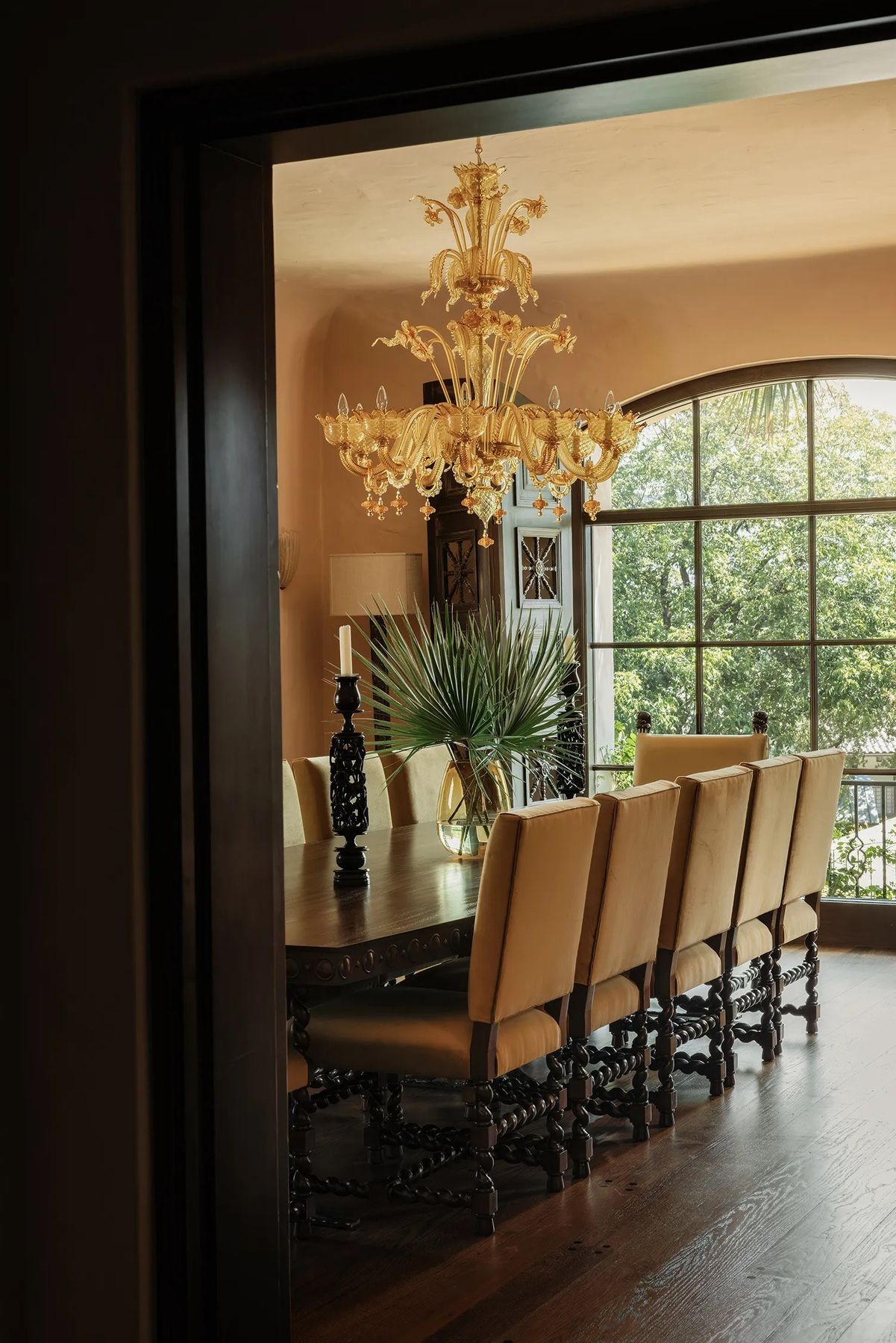 dining room seen through a doorway, arched window beyond