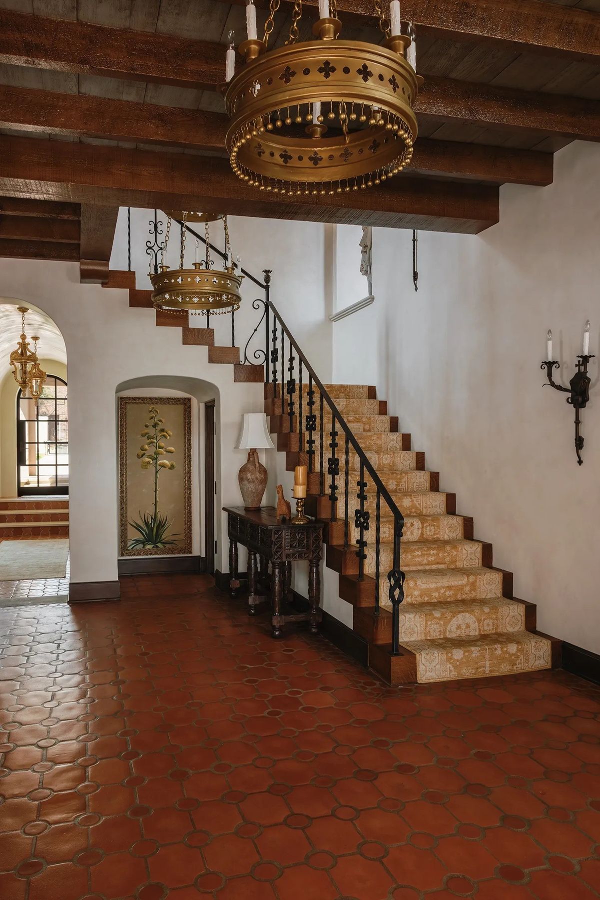 entry hall with a tiled stair and an iron rail