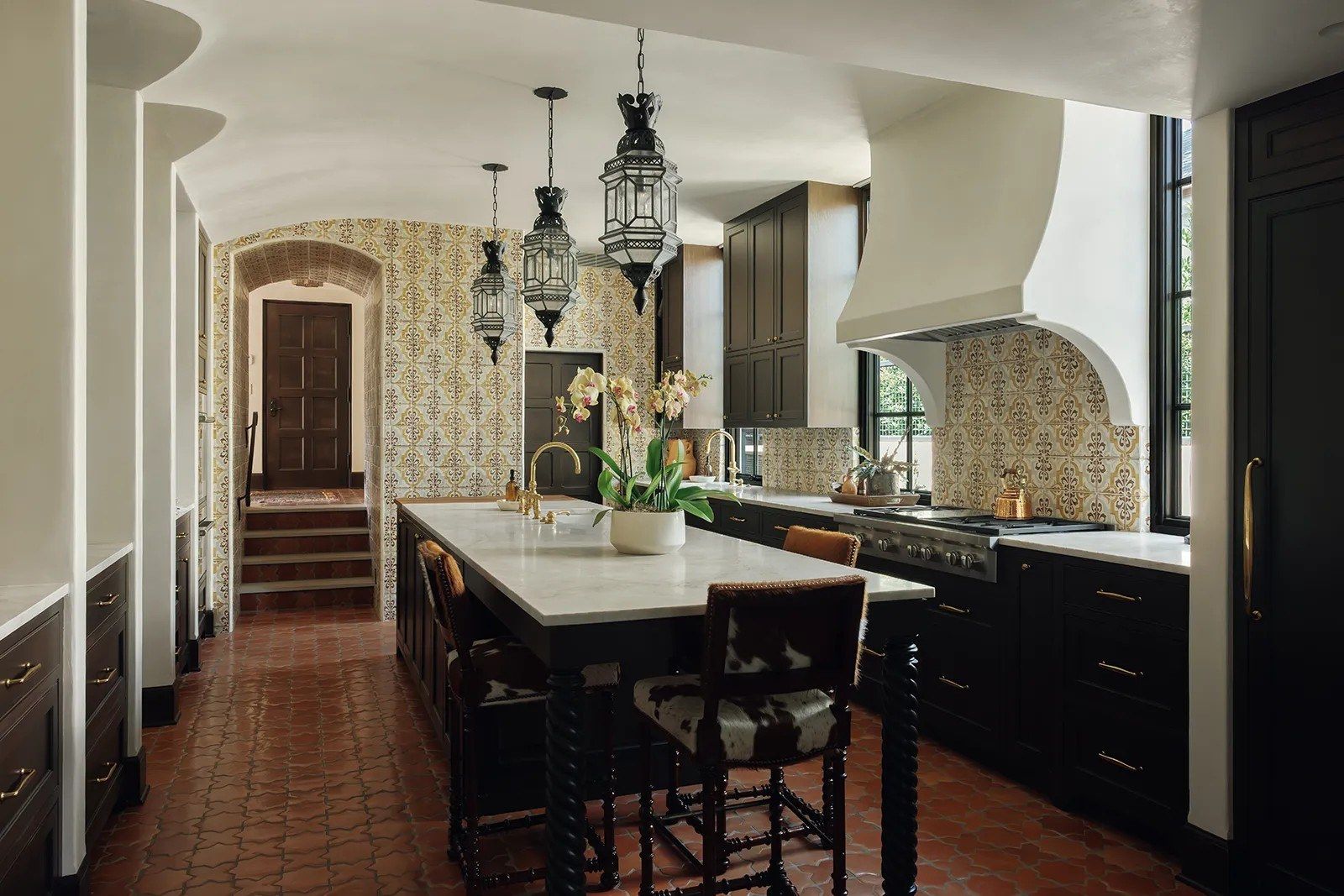 kitchen with a long island and a plaster hood